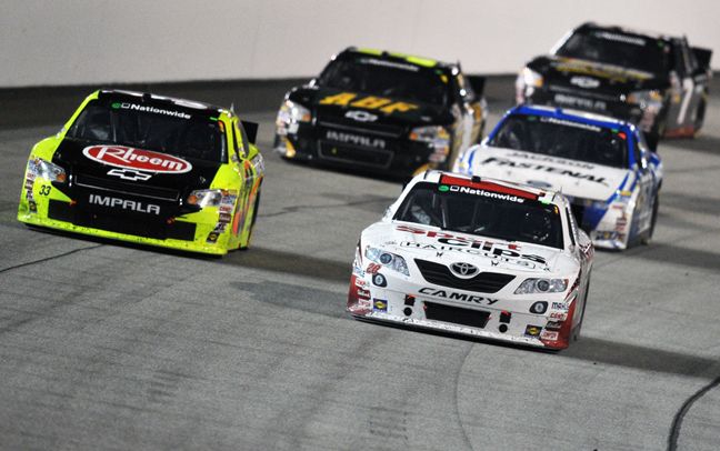 Denny Hamlin races second-place finisher Paul Menard during the BUBBA Burger 250 at Richmond International Raceway. Credit: Drew Hallowell/Getty Images